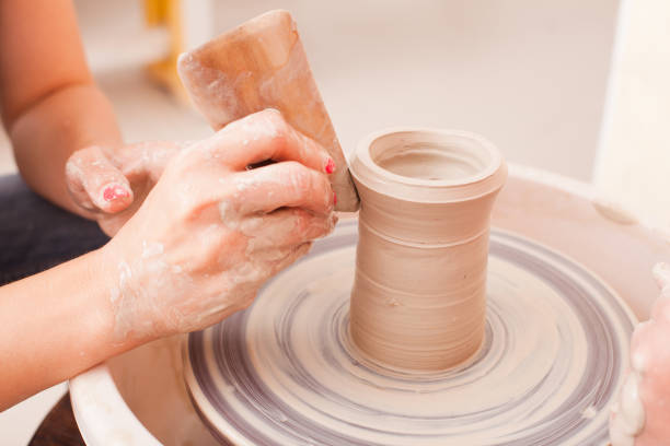 istock Hands Shaping Clay On Pottery Wheel 1317273570
