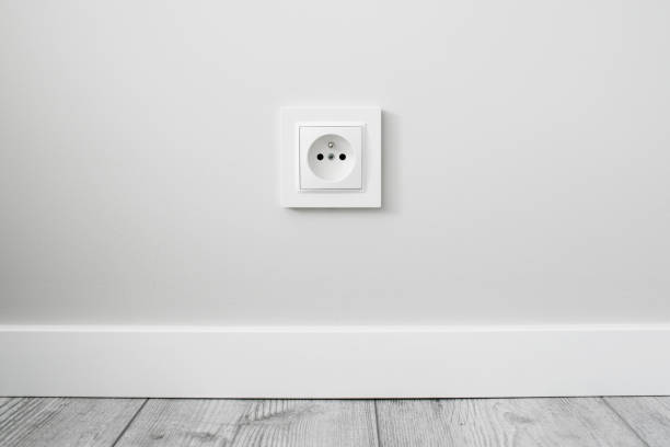 istock New electrical socket isolated on gray wall. Renovated studio apartment power supply background. 1317273656