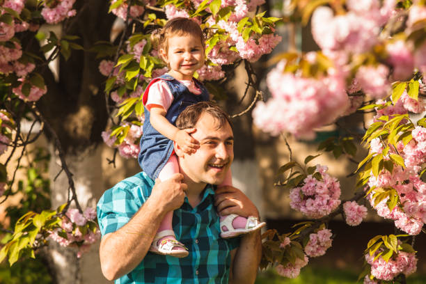 istock Father Carrying Daughter On Shoulder 1317273714