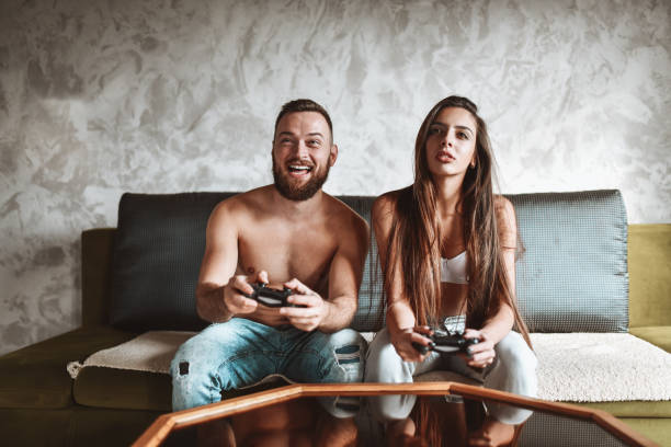 istock Smiling Couple Having Video Game Competition At Home 1317275314