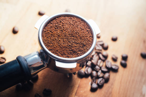 istock Portafilter with grounded coffee and coffee beans close-up 1317275722