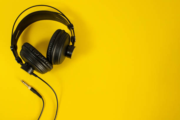 istock Guitar, headphones, microphone and staff notebook. 1317275858