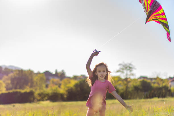 istock Child running whit kite on the meadow 1317275906