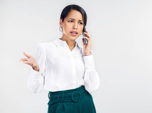 Studio shot of a young businesswoman using a smartphone and looking upset against a grey background What do you mean we lost the contract? phone spam photos stock pictures, royalty-free photos & images