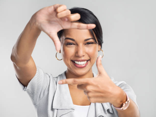 Studio shot of a confident young businesswoman making a frame with her fingers against a grey background Dream bigger, do better gesturing photos stock pictures, royalty-free photos & images