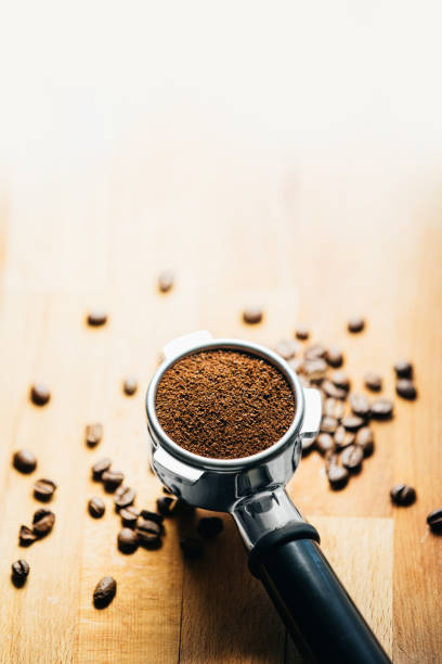 istock Portafilter with grounded coffee and coffee beans close-up 1317276692