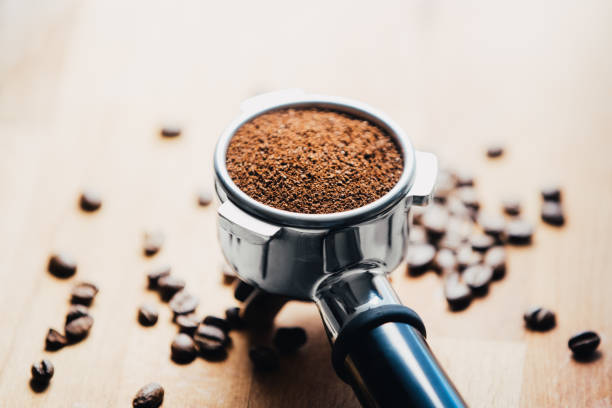 istock Portafilter with grounded coffee and coffee beans close-up 1317276715