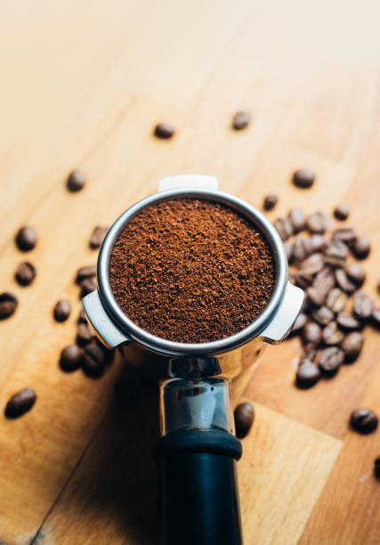 istock Portafilter with grounded coffee and coffee beans close-up 1317276772