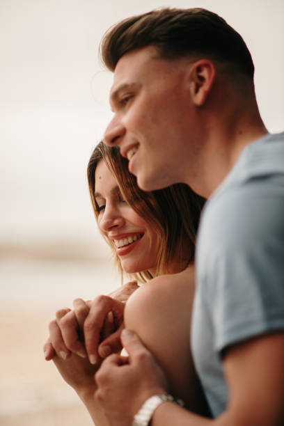istock Young couple in love by a window 1317278338
