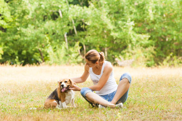 istock Young Woman With Dog On Field 1317279221