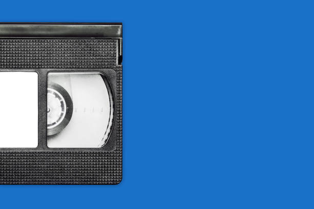 istock Black vhs tape isolated on blue. Outdated technology background. 1317279340