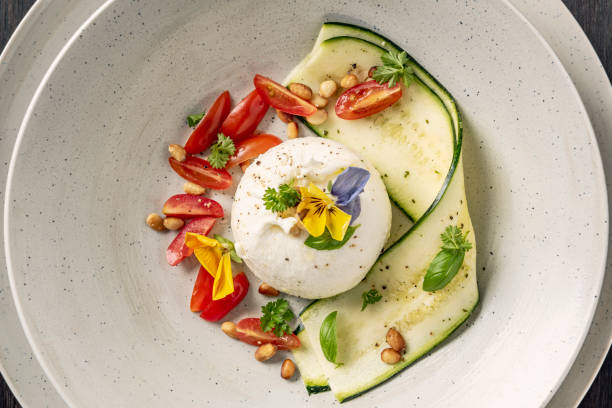 Burrata with Sliced Zucchini with Tomatoes and a Pesto Dressing.
