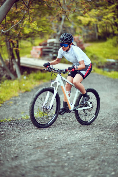 istock Female Cyclist Focused On Difficult Hill Climb During Mountain Biking 1317280596