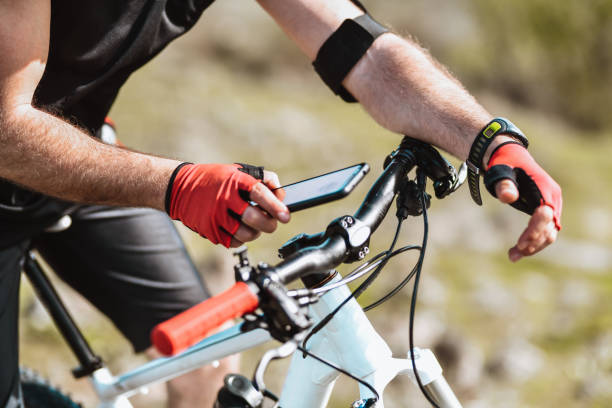 istock Male Cyclist Setting Up Smartphone Map While Cycling On Mountain 1317280689