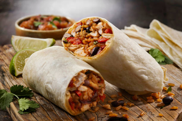 Mexican Rice and Chicken Burrito Mexican Rice and Chicken Burrito with Black Beans, Roast Peppers and Fresh Cilantro burrito photos stock pictures, royalty-free photos & images