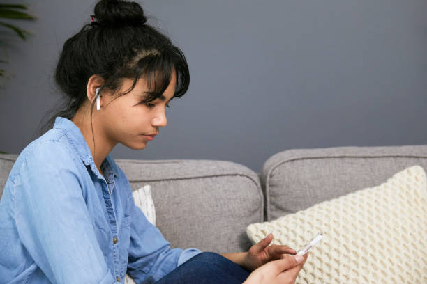 istock Sad teenage looking at her phone 1317280960