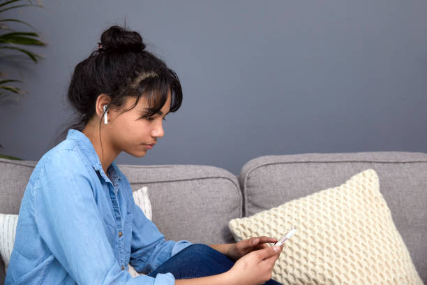 istock Sad teenage looking at her phone 1317280965