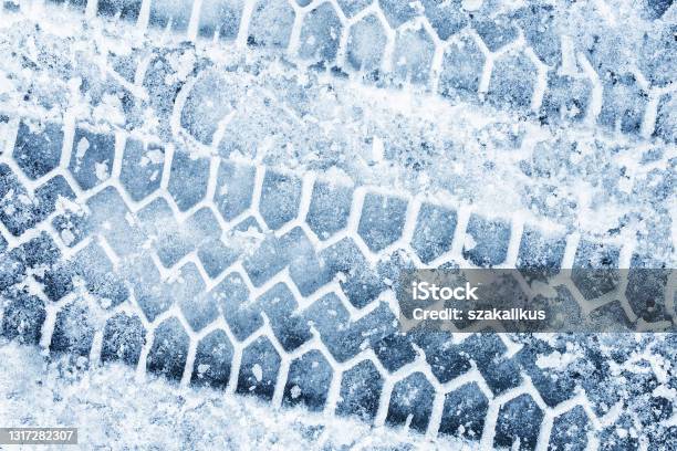 Snow Tyre Mark Asphalt Covered In Snow Dangerous Road Conditions Car Imprint On Frozen Ground Tire Trail On Ice Stock Photo - Download Image Now