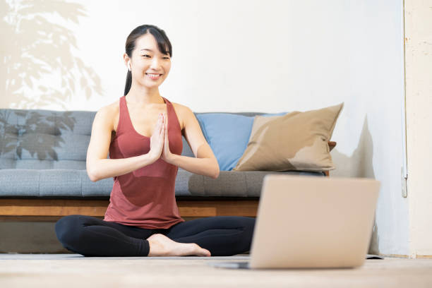 istock A woman doing yoga while looking at the computer screen 1317283637