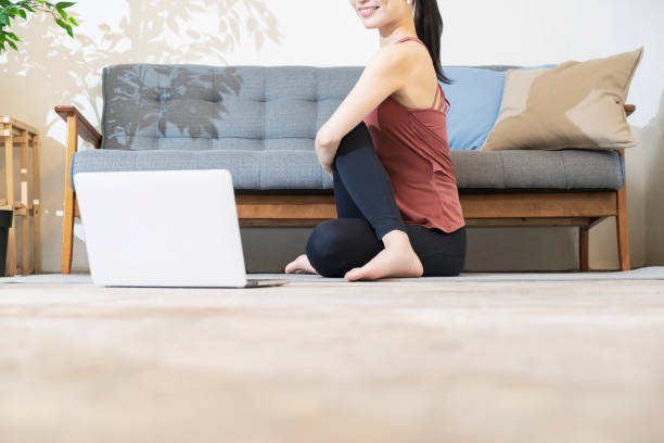 istock A woman doing yoga while looking at the computer screen 1317283690