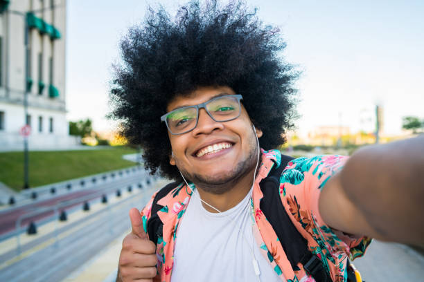 istock Latin man taking a selfie outdoors. 1317284003