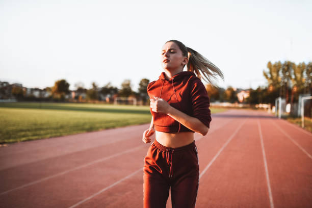 istock Cute Female Running On Track During Sunset 1317284184