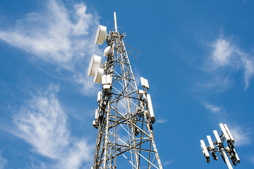 Radio, comunicación y torres celulares sobre fondo azul del cielo photo