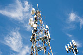 Radio, communication and cell towers on blue sky background