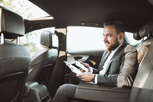 istock Smiling Modern Businessman Working While On The Way To Meeting 1317286030