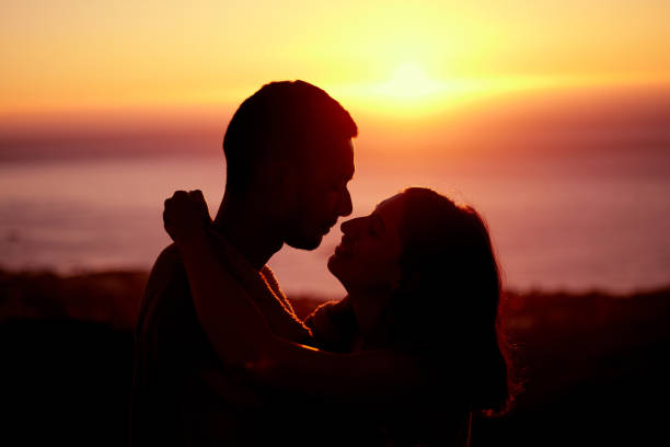 istock Cropped shot of an affectionate young couple silhouetted at sunset 1317287681