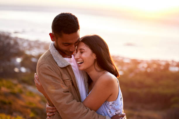 istock Cropped shot of an affectionate young couple embracing lovingly at sunset 1317287697