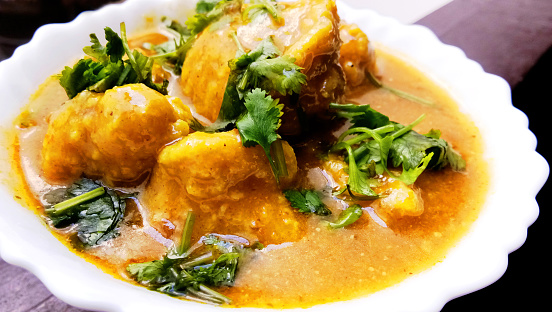 Homemade kashmiri dum aloo: spicy potato closeup on the pan on the table