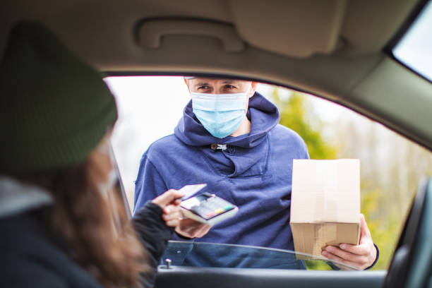 istock Young adult woman received package from courier 1317288573