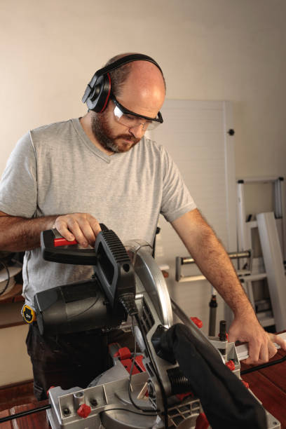 istock Carpenter working with an electric cutting machine, circular saw. 1317288681