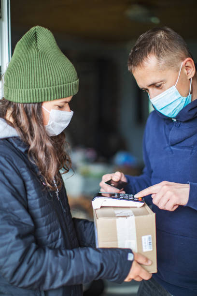 istock Young adult woman received package from courier 1317288898