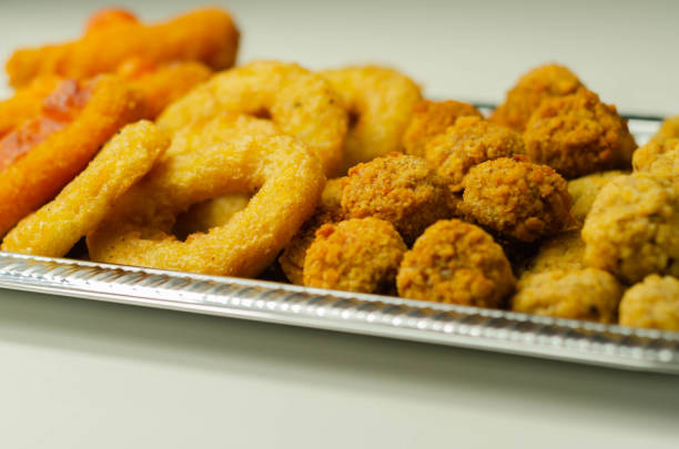 Southern fried and roast chicken bites, onion rings and mozzarella stick served on the silver tray, party bites