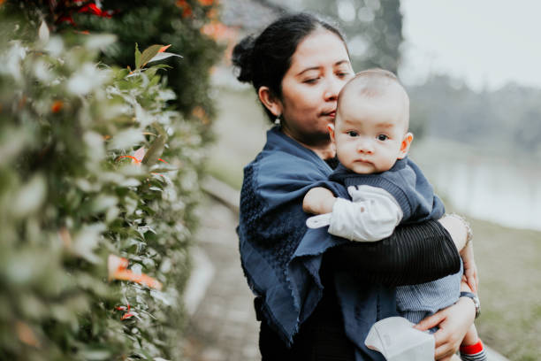 istock mother with baby in the park 1317292311