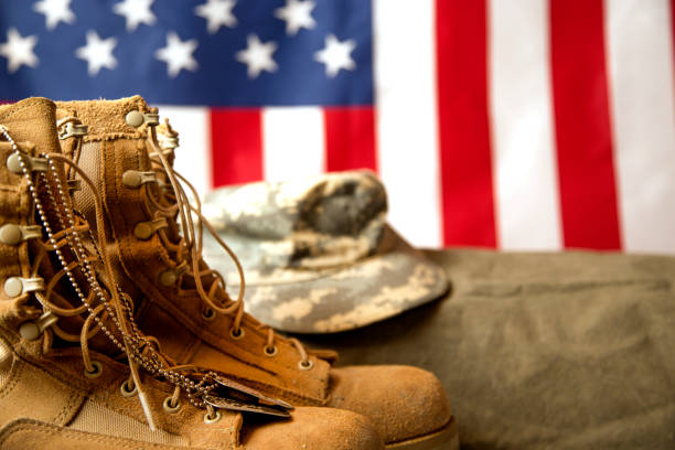 istock US Military Display.  Modern day military boots and cap. 1317293418