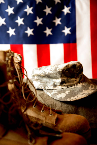 istock US Military Display.  Modern day military boots and cap. 1317293428