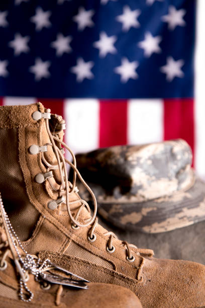 istock US Military Display.  Modern day military boots and cap. 1317293457