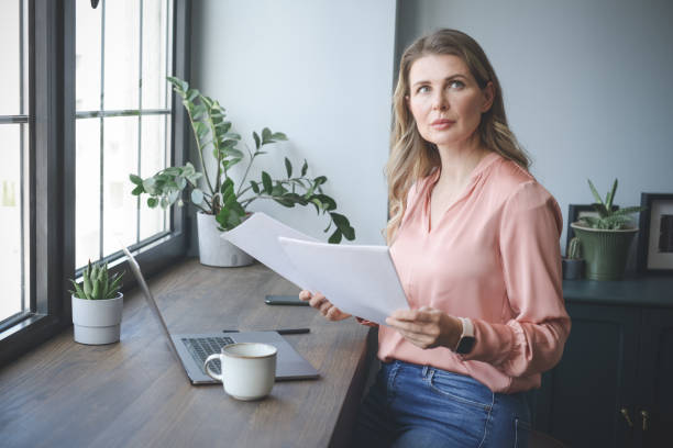 istock attractive middle aged woman working in the office 1317293559