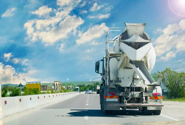 Concrete truck mixer on construction in trafic.
