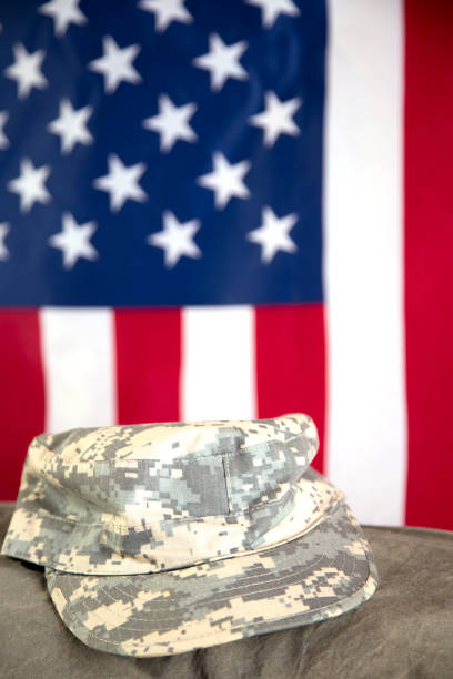 istock US Military Display.  Modern day military boots and cap. 1317293571