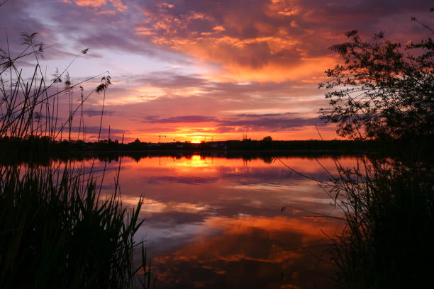 istock Amazing landscape with dramatic sky and clouds over the water. 1317293697