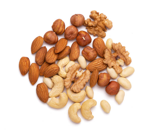 istock Mix of nuts close up isolated on white background 1317294731