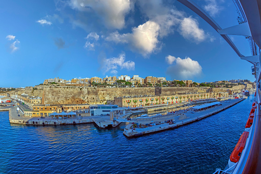 Valletta: Part of Valletta Waterfront, also known as Pinto Wharf or Pinto Stores, a baroque wharf in Floriana, with colourful windows, the old seawall and Cruise Ship Pier.