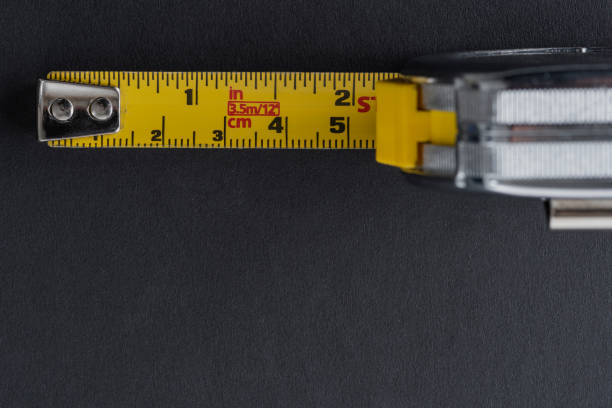 istock Flexometer or meter to measure in silver and yellow with black background 1317297331