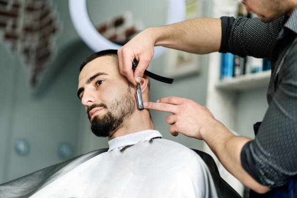 istock Man getting his beard trimmed with a razor blade 1317297404