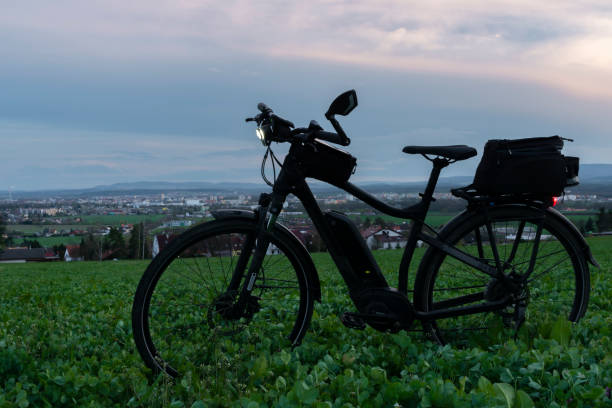 istock Black and gray electric bicycle in sunset time with cloudy sky 1317299709