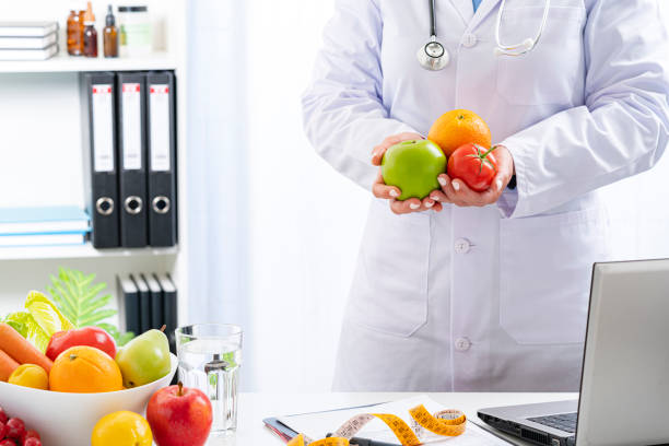 istock Nutritionist holding some fruits and vegetables 1317299749